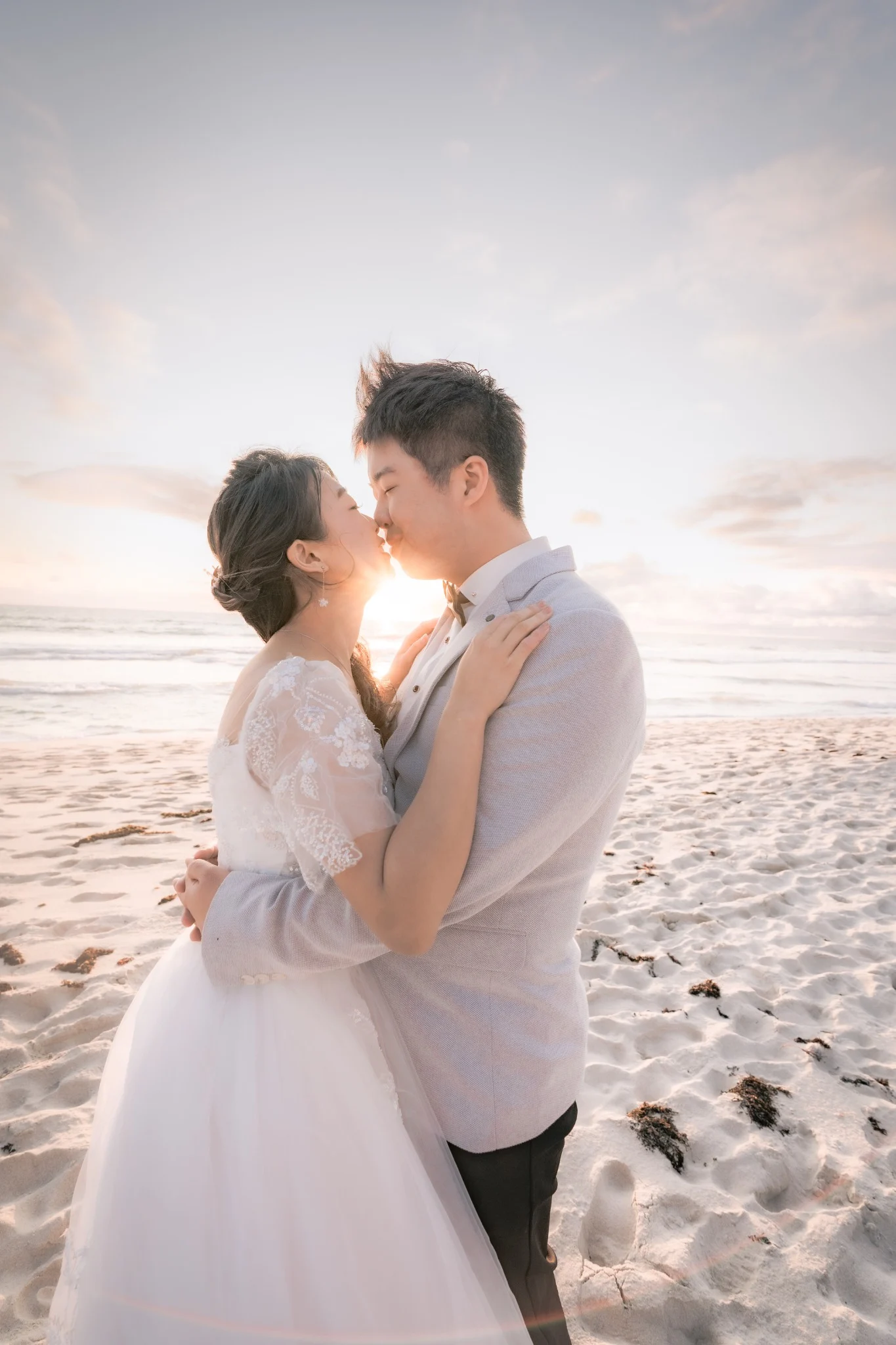 Angle and Andrew sharing a sunset kiss at Burns Beach in Perth, Western Australia