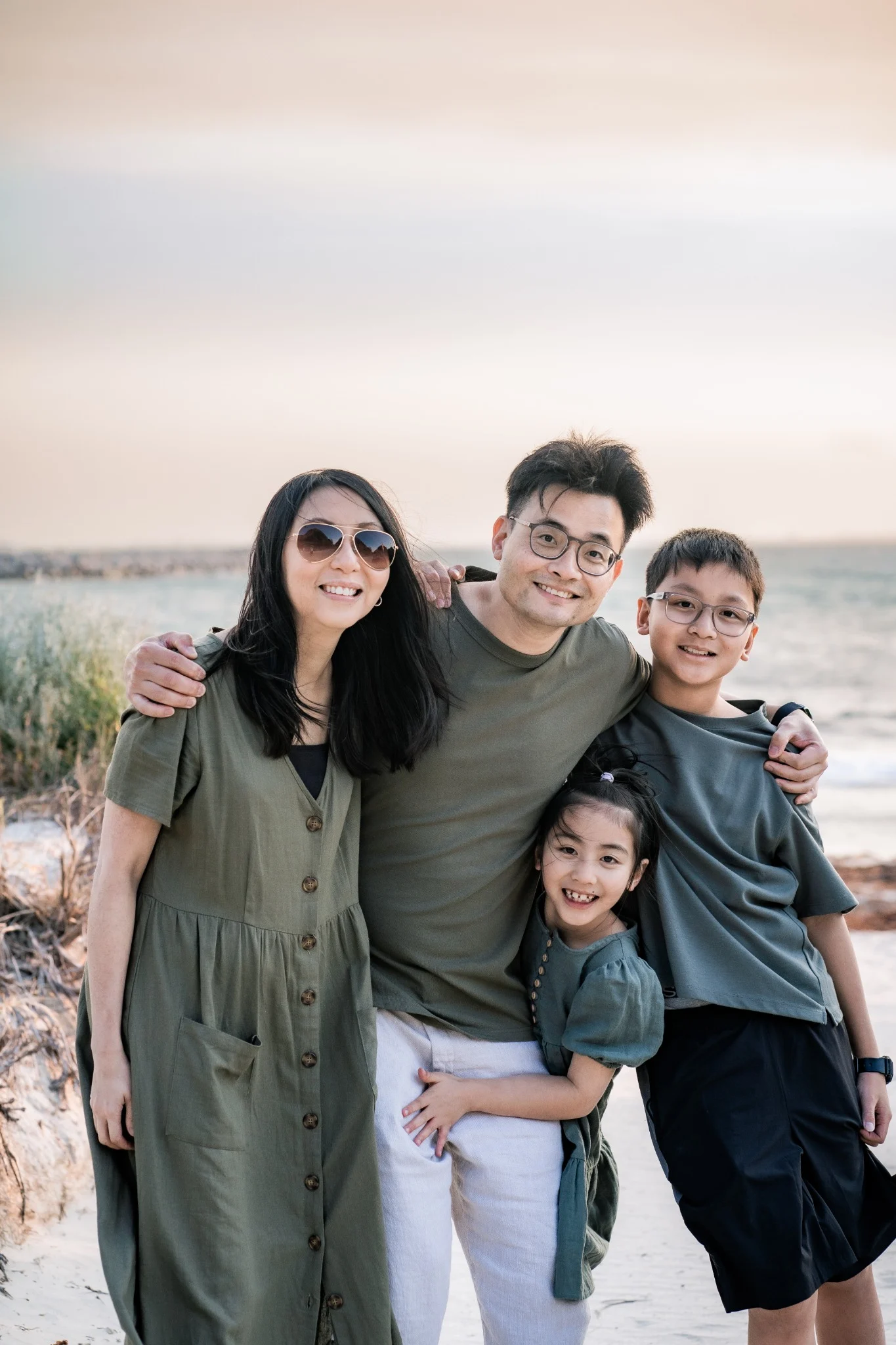 The Chan's Family lined up along a peach wall in Fremantle