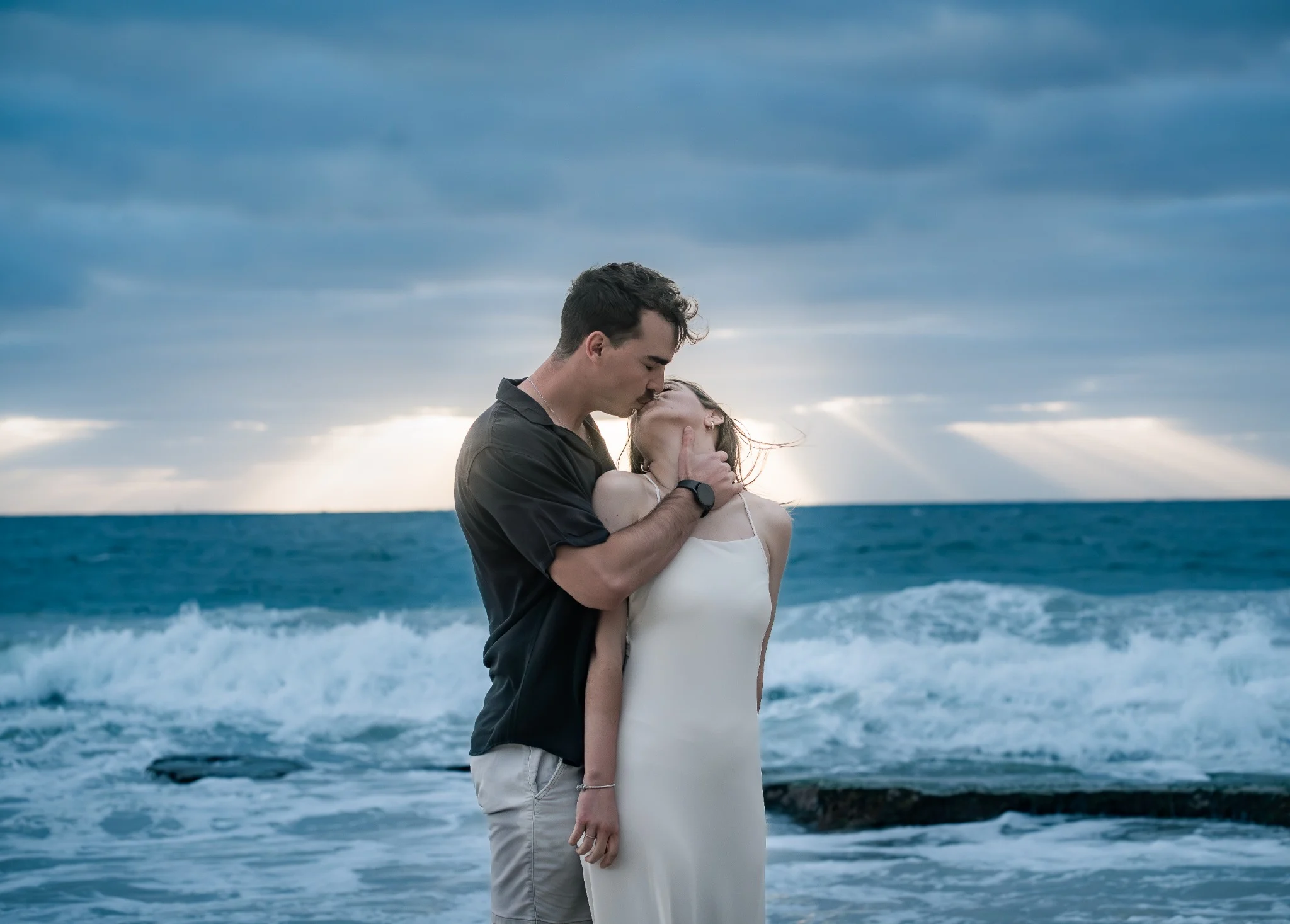 Marcja and Henrico sharing an intimate kiss beside the waves at Cottesloe Beach