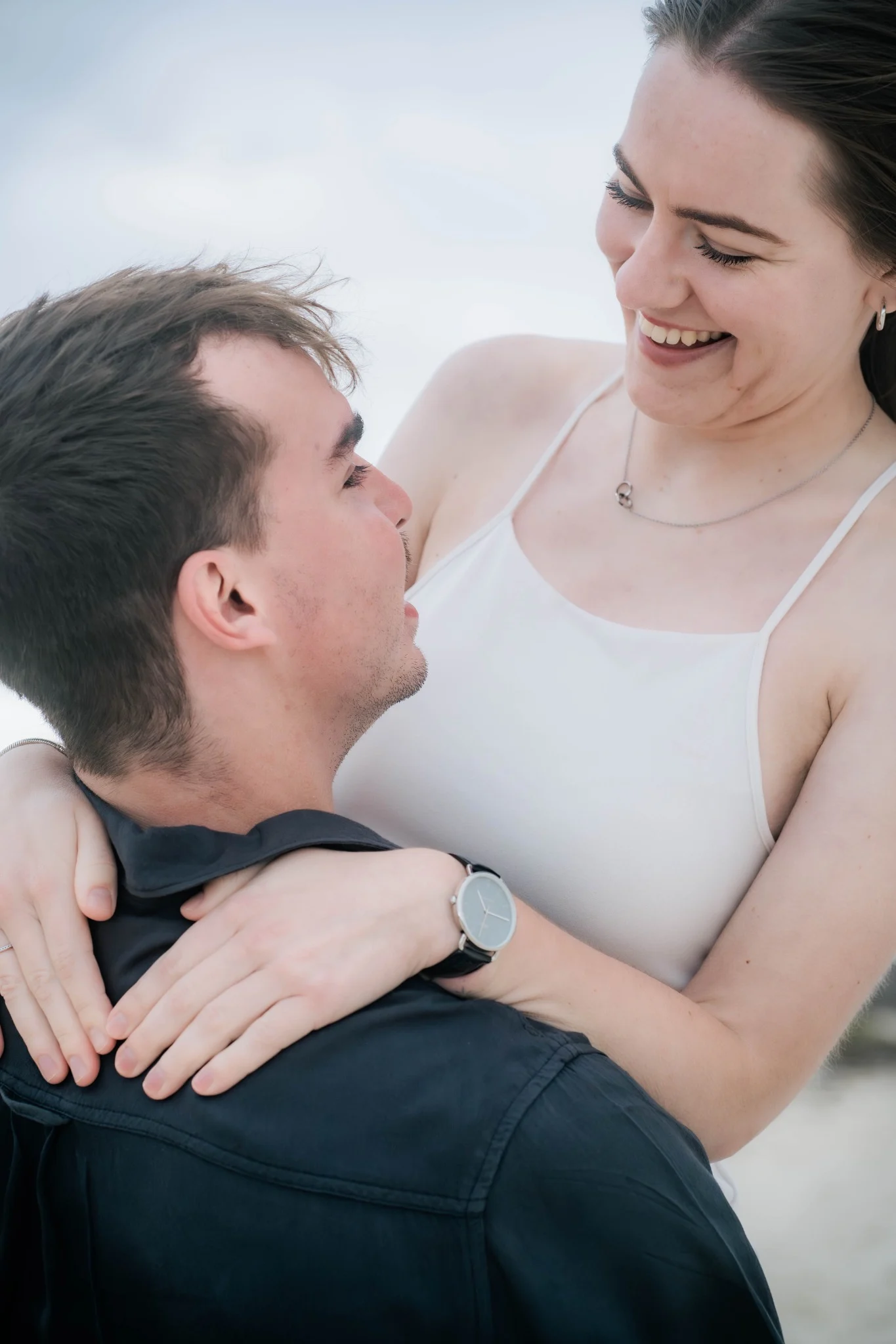 Marcja laughing with Henrico during their Cottesloe Beach engagement session