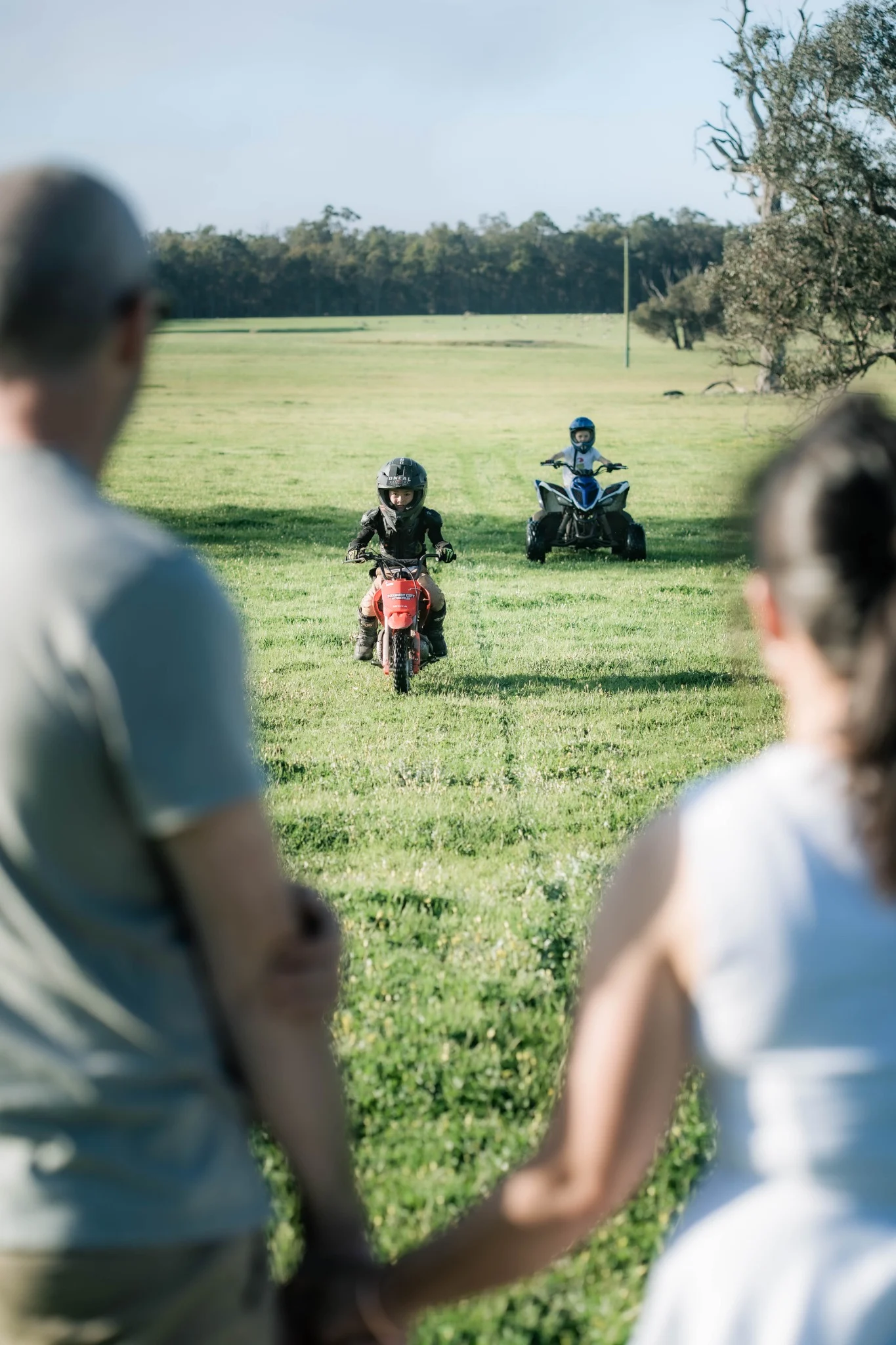 Children riding motorbikes on a farm near Perth, Western Australia